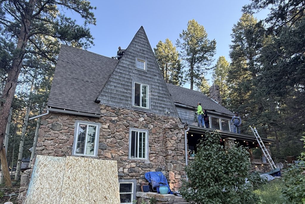 Crew completing residential roof replacement on Colorado home