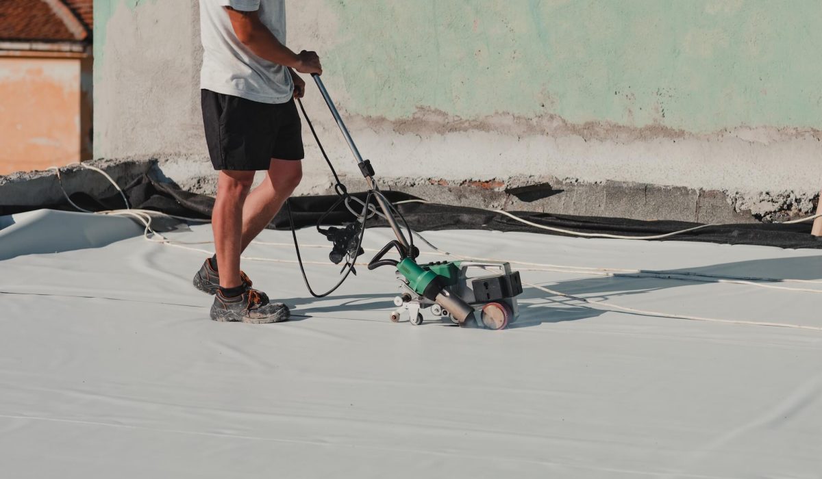 roofing contractor heat-welding seams on TPO membrane