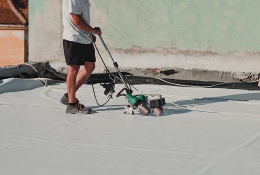 roofing contractor heat-welding seams on TPO membrane