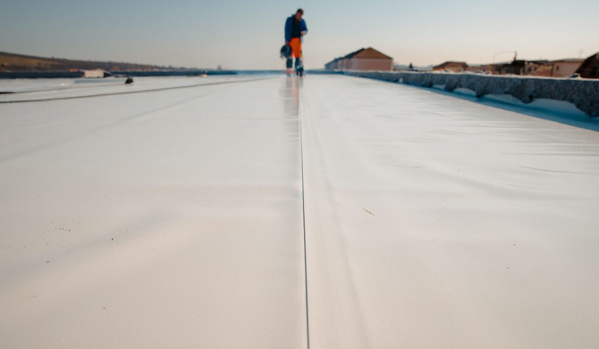 Roof technician repairing seam on TPO membrane