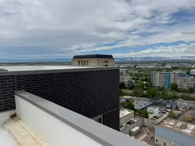 Multifamily roof repair services completed on damaged apartment building roof in Denver
