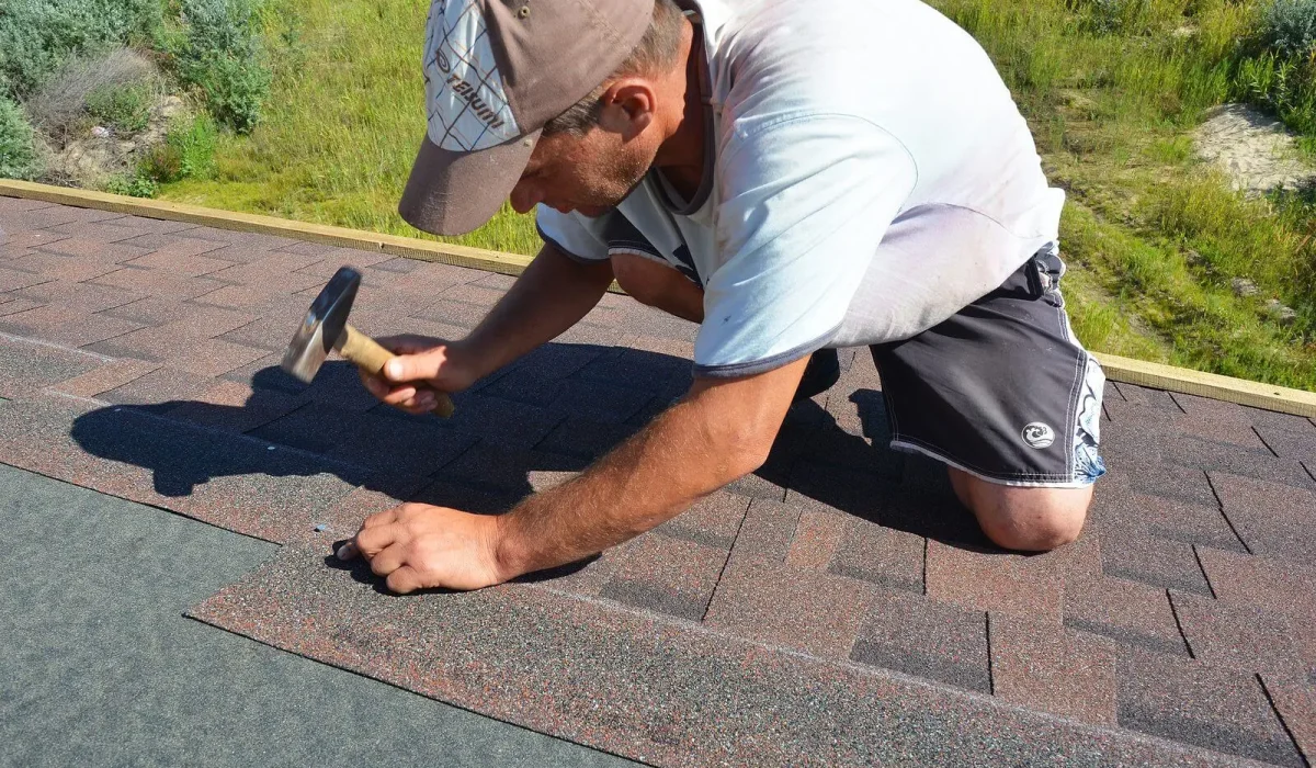 Technician performing maintenance inspection on a low-slope commercial roof.