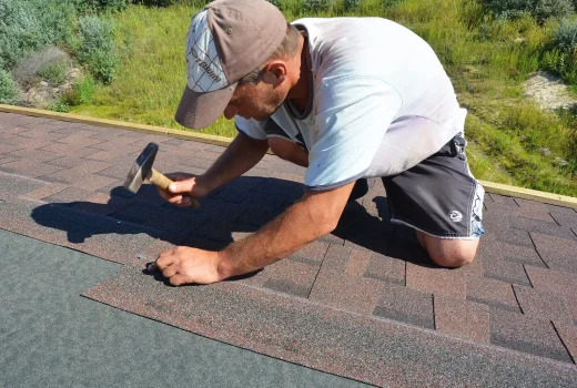 Technician performing maintenance inspection on a low-slope commercial roof.