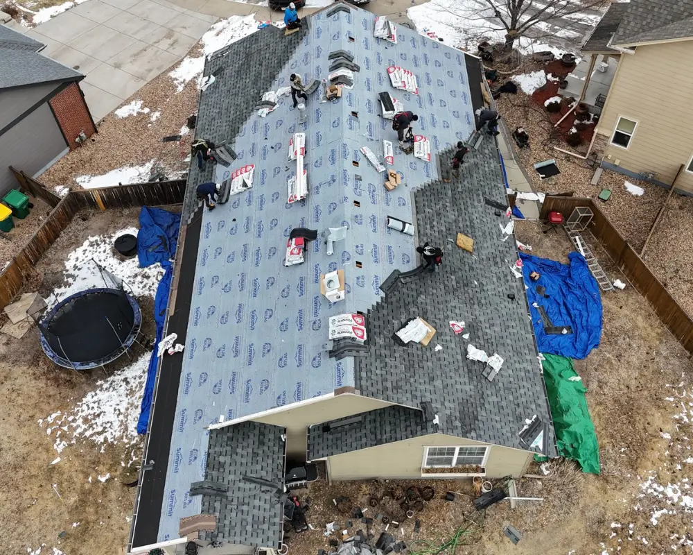 Aerial view of synthetic underlayment and shingle installation in progress