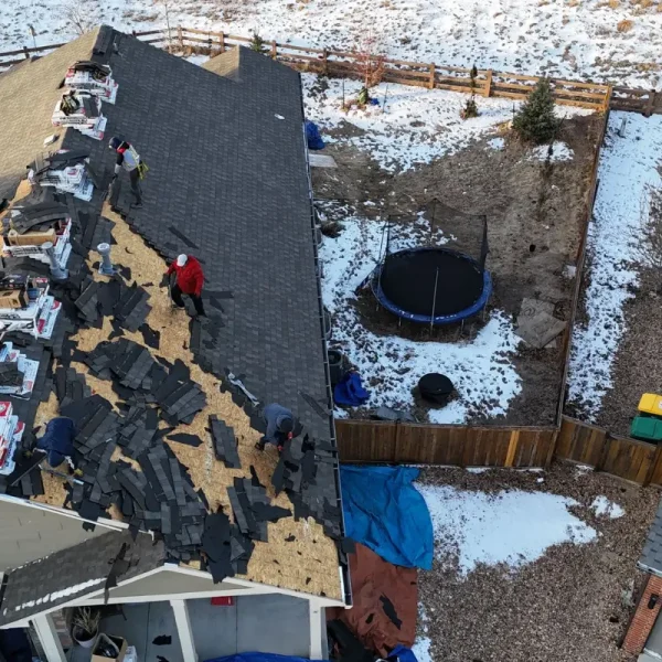 Aerial view of residential roof tear-off and new shingle installation