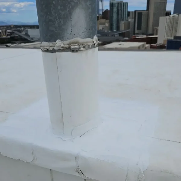 Close-up of TPO membrane showing wall tenting and separation requiring commercial roof maintenance.
