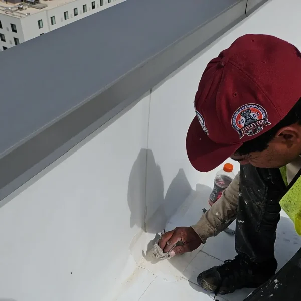 TPO membrane pulled away from parapet wall during commercial roof inspection at Civic Lofts in Denver.