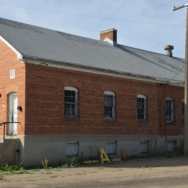 Historic DHS Building 87 at Fort Logan before its roof replacement, showing the aging roof