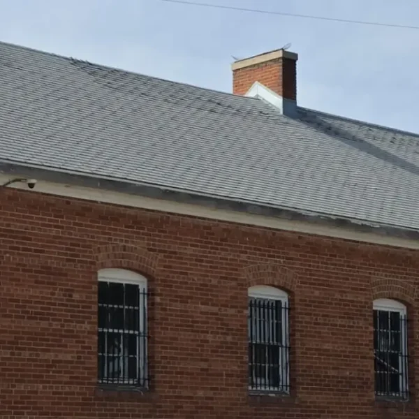 Ground-level view of DHS Building 87's brick facade and newly completed roof in Denver, Colorado