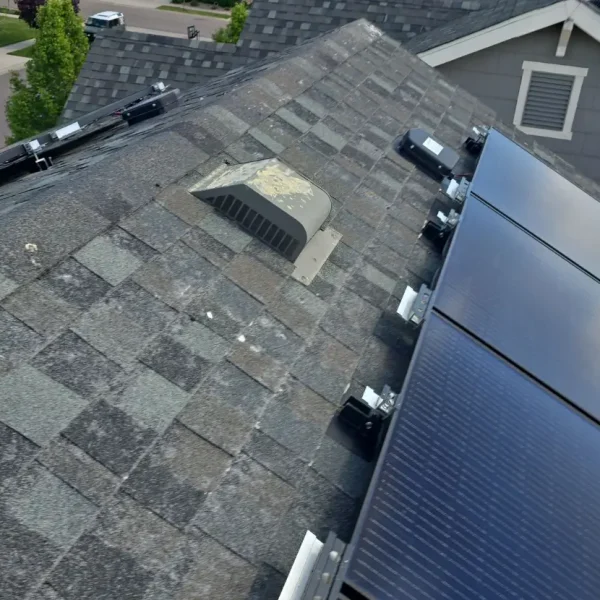 Residential roof in Erie Colorado showing missing shingles from wind damage