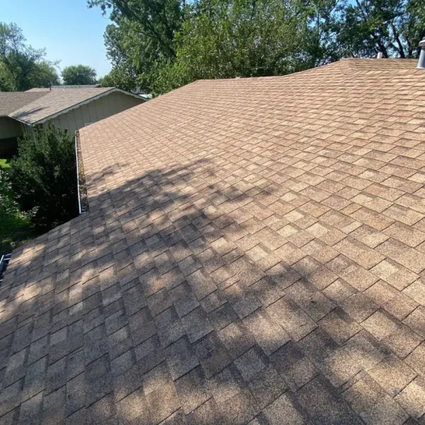 Existing asphalt shingle roof on a McPherson home before the insurance-approved roof replacement.