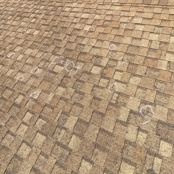 Existing asphalt roof in McPherson, KS marked during an inspection for hail and storm damage.