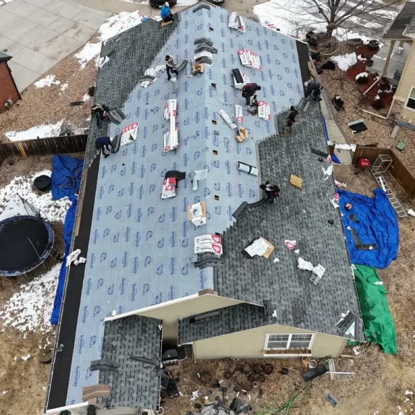 Aerial view of synthetic underlayment and shingle installation in progress